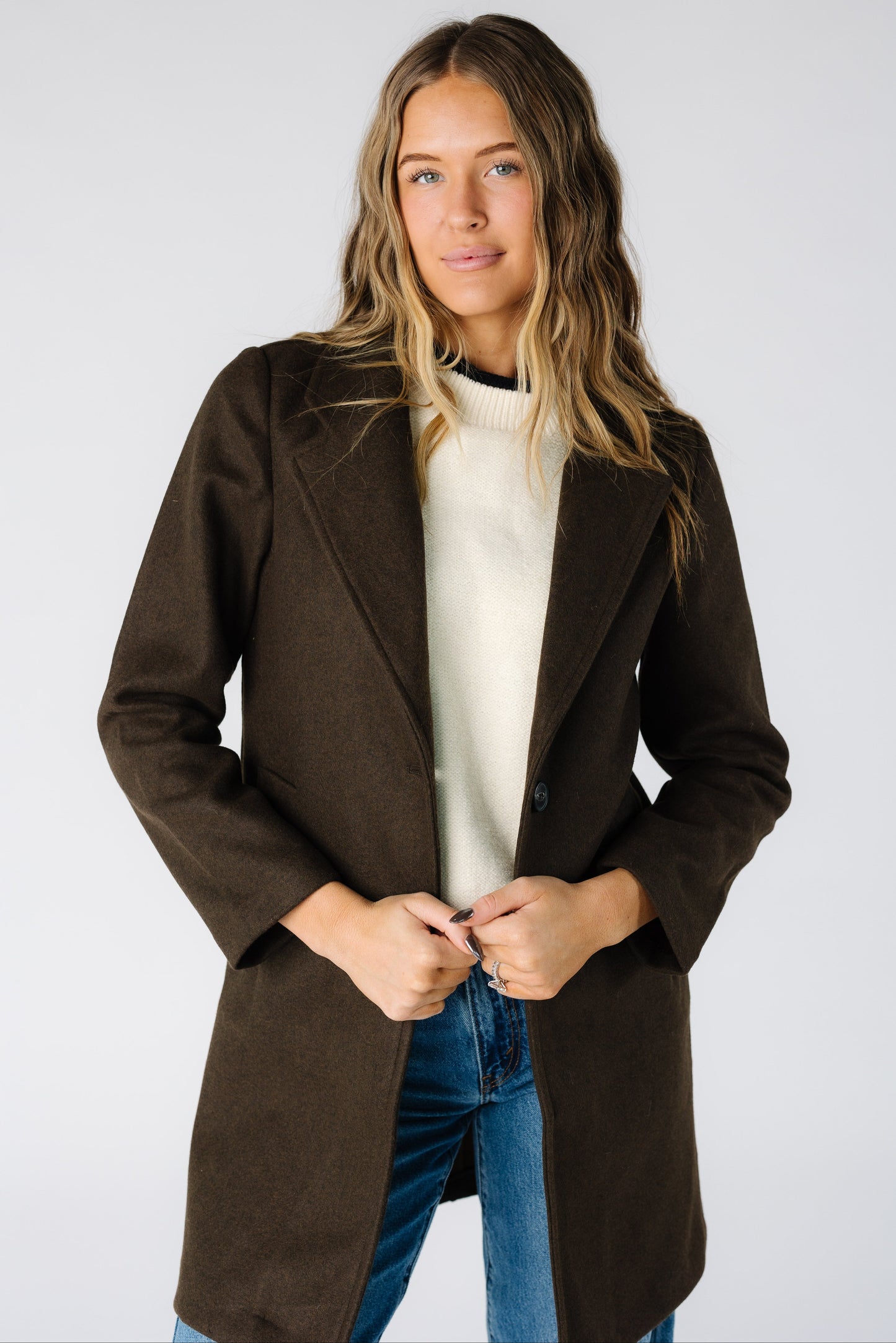Woman wearing a modest long sleeve jacket in dark brown