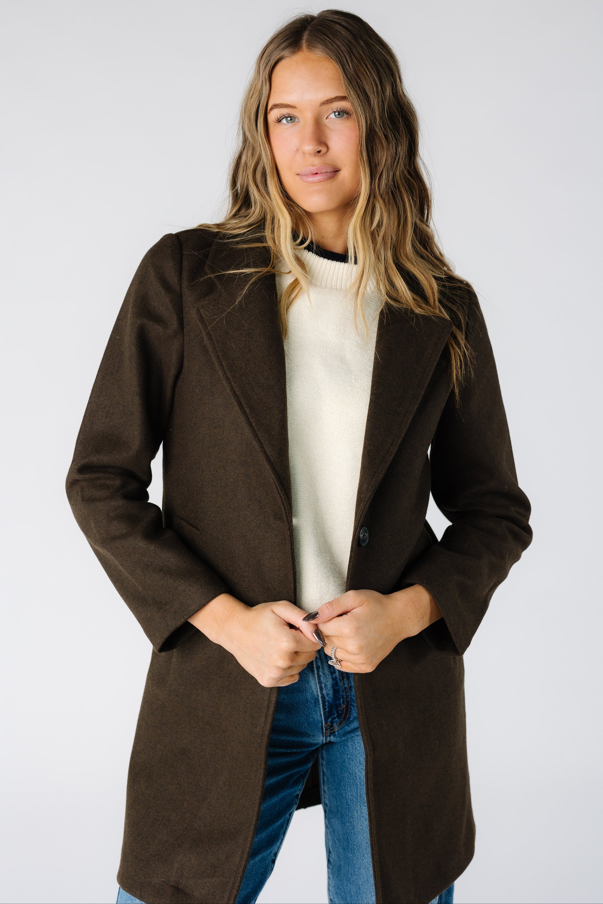 Woman wearing a modest long sleeve jacket in dark brown