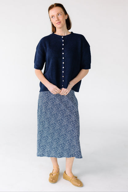Woman wearing a modest A-line midi skirt in navy and white.