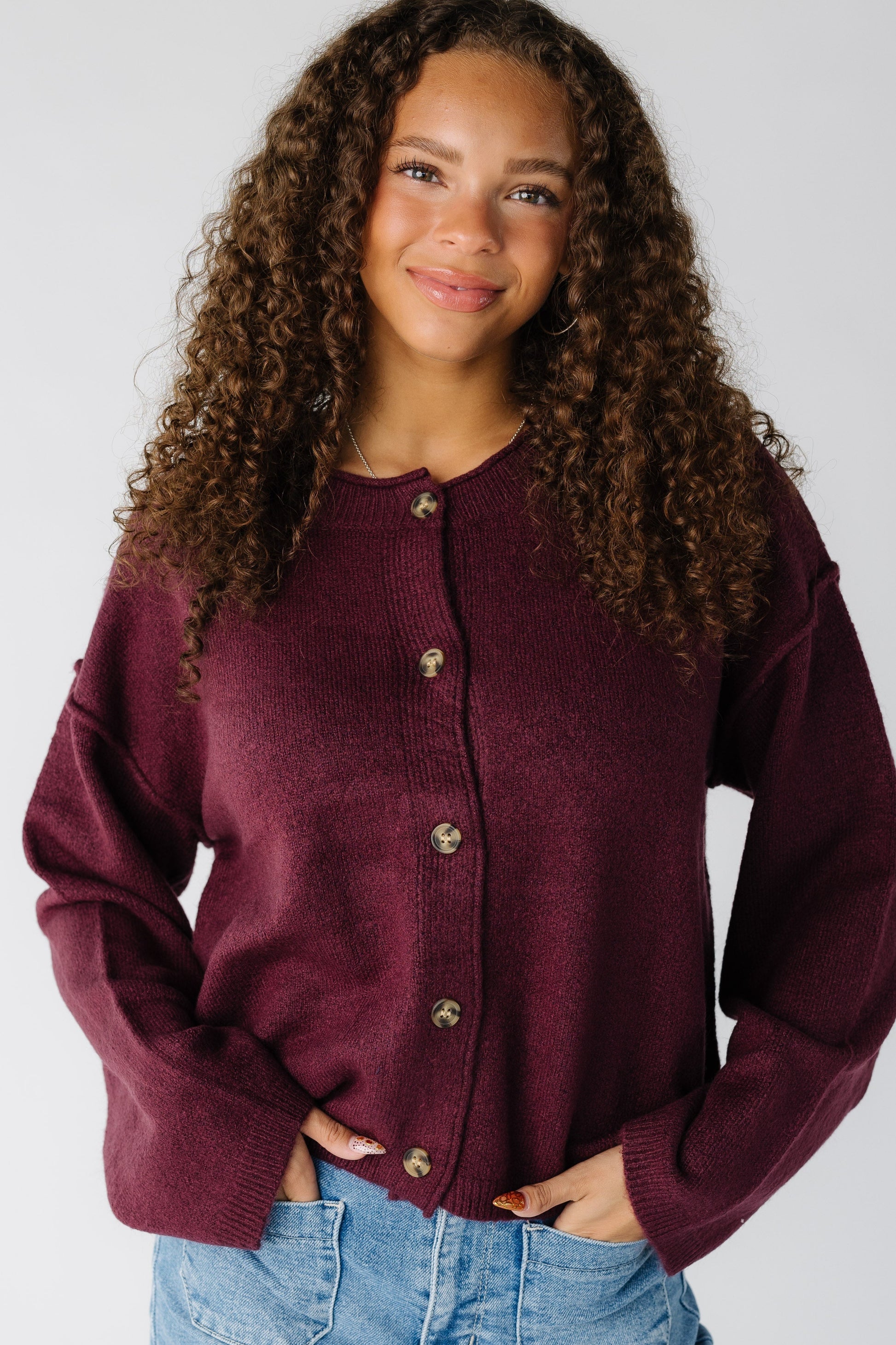 Woman wearing a modest long sleeve button cardigan with a crew neckline and long sleeves