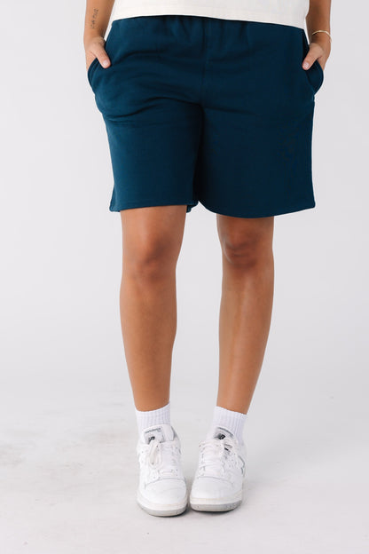 Woman wearing wide leg navy shorts
