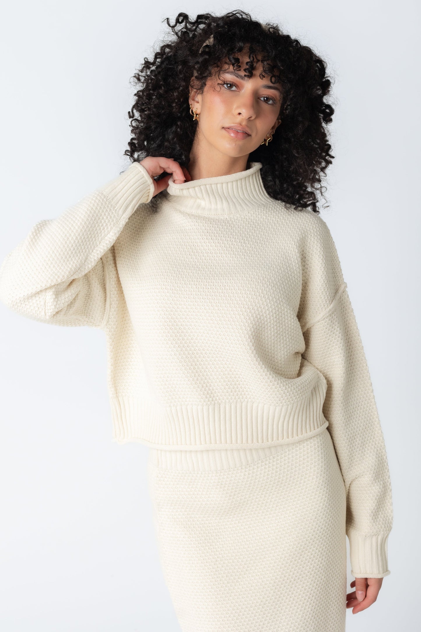 Cream mock turtleneck sweater in cream with matching textured skirt