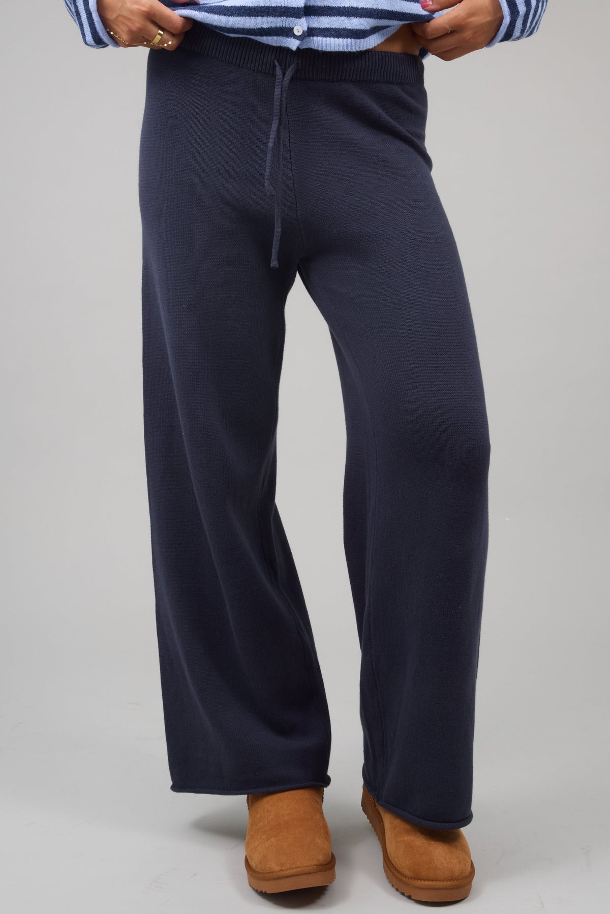 Young woman wearing modest nay sweater knit lounge pants.