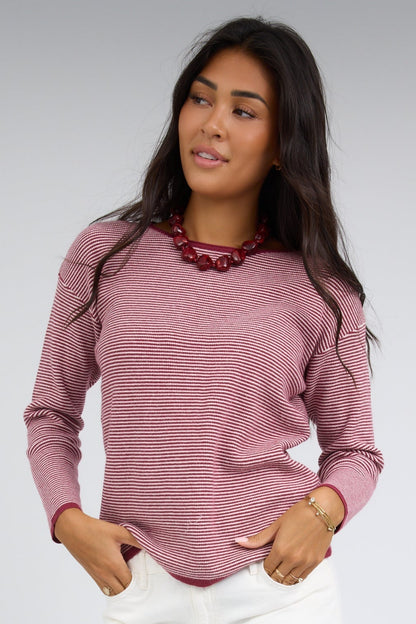 Young woman wearing a modest burgundy & white stripe top with long sleeves and a round neckline.