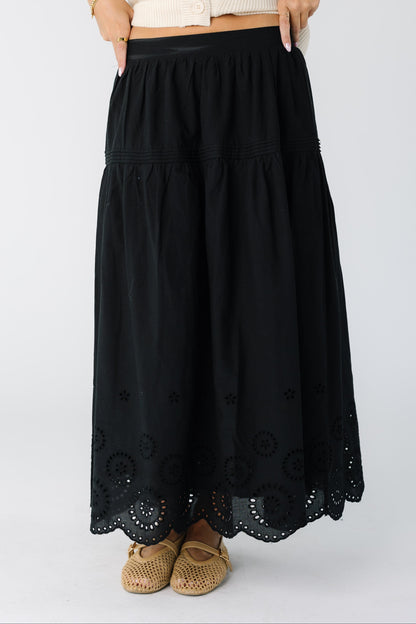 Woman wearing a black eyelet midi skirt