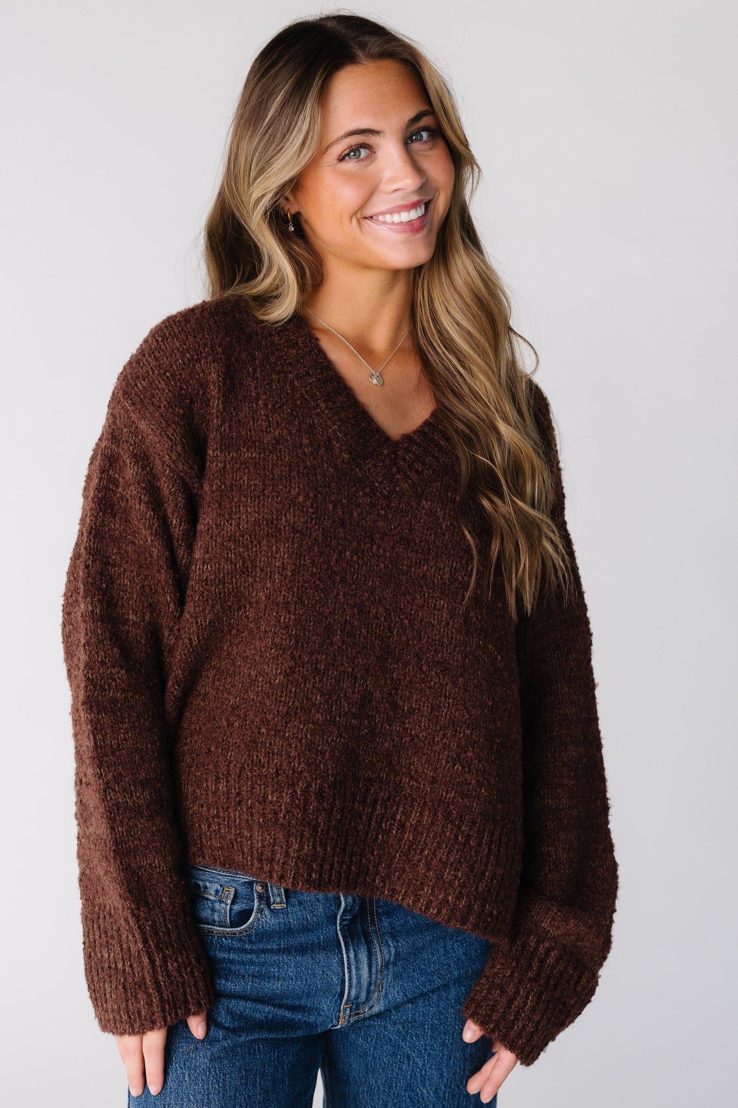 Woman wearing a brown loose fitting sweater