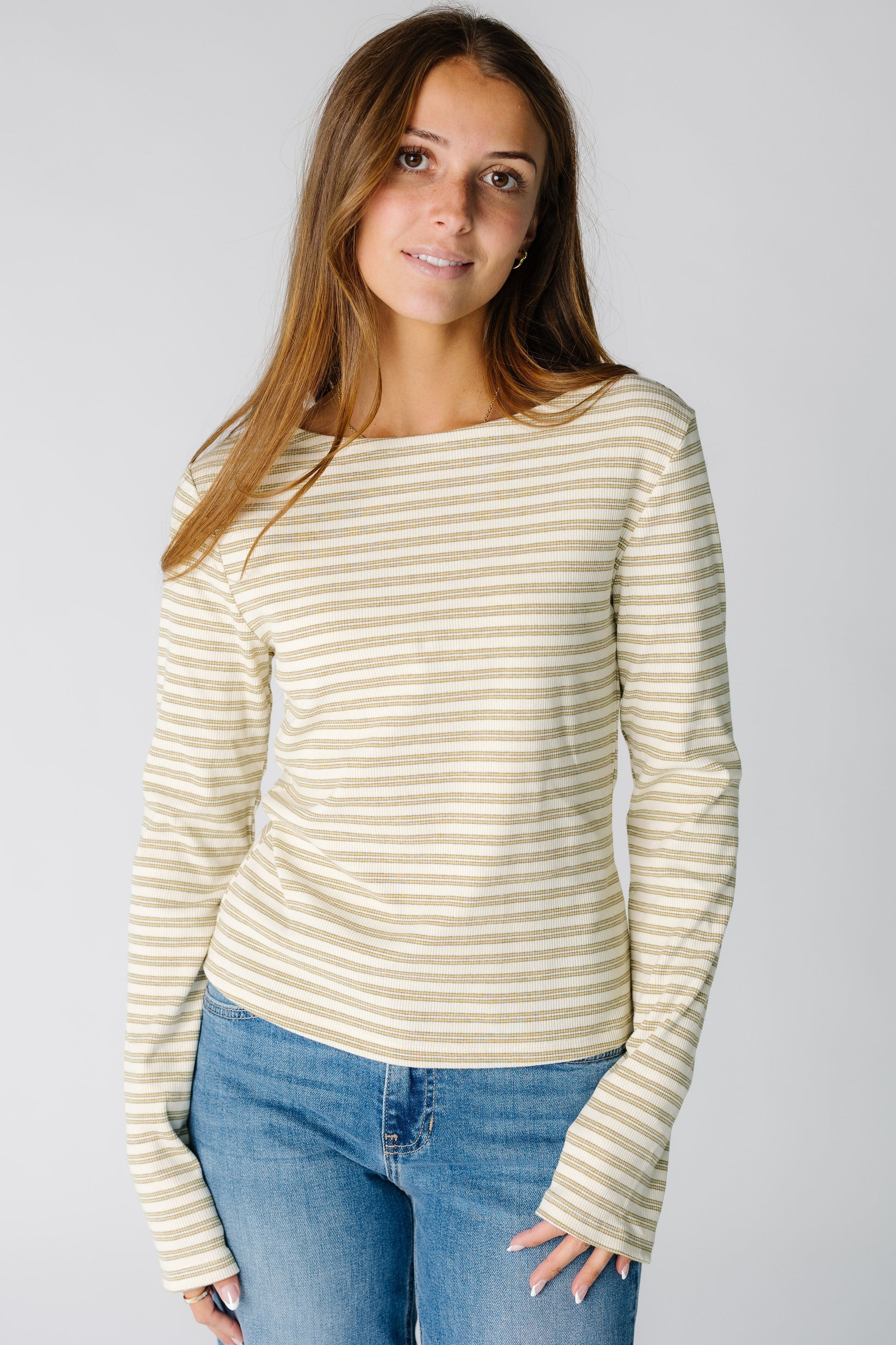 Woman wearing a yellow ribbed and stripe long sleeve top