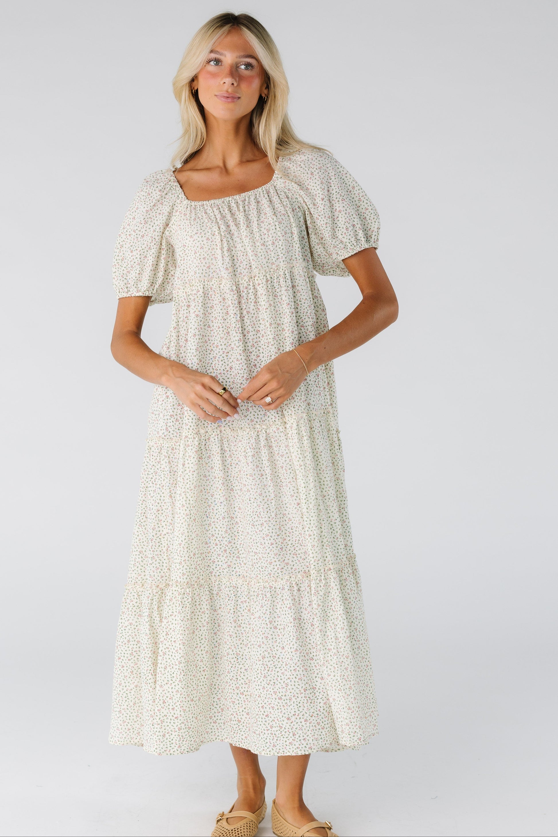 Woman in a floral cream midi dress
