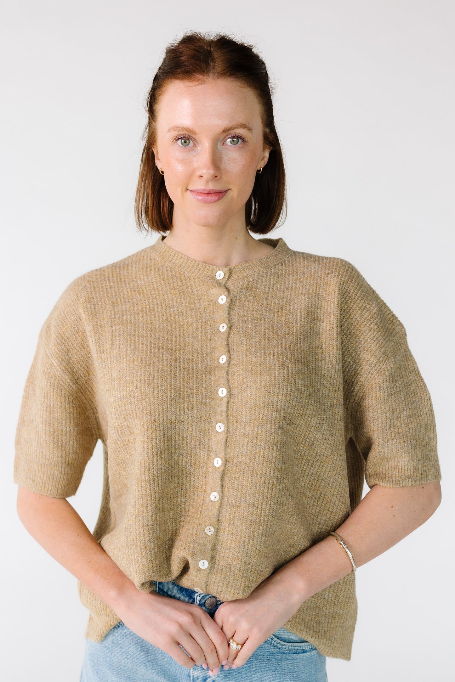 Woman wearing a modest rib knit cardigan in latte tan with short sleeves.