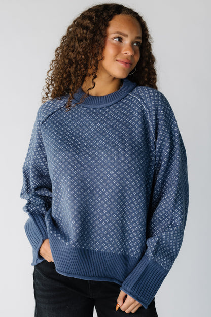 Teen girl wearing a modest blue patterned pullover sweater with long raglan sleeves and crew neckline