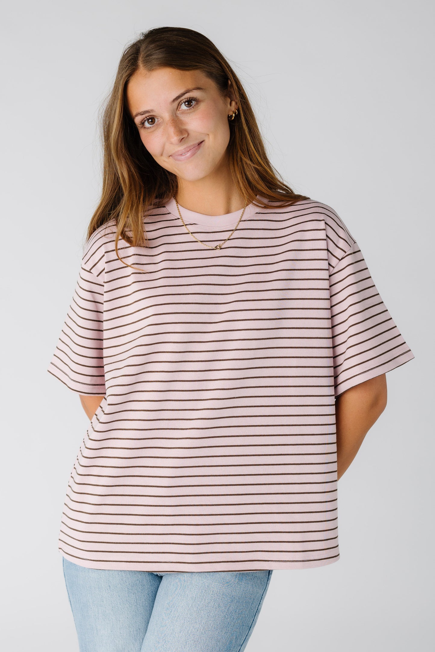 Woman wearing a pink stripe tee with a crew neckline and short sleeves