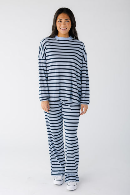 Young woman wearing a modest dark blue & light blue ribbed lounge set with long sleeves and long wide cut legs.