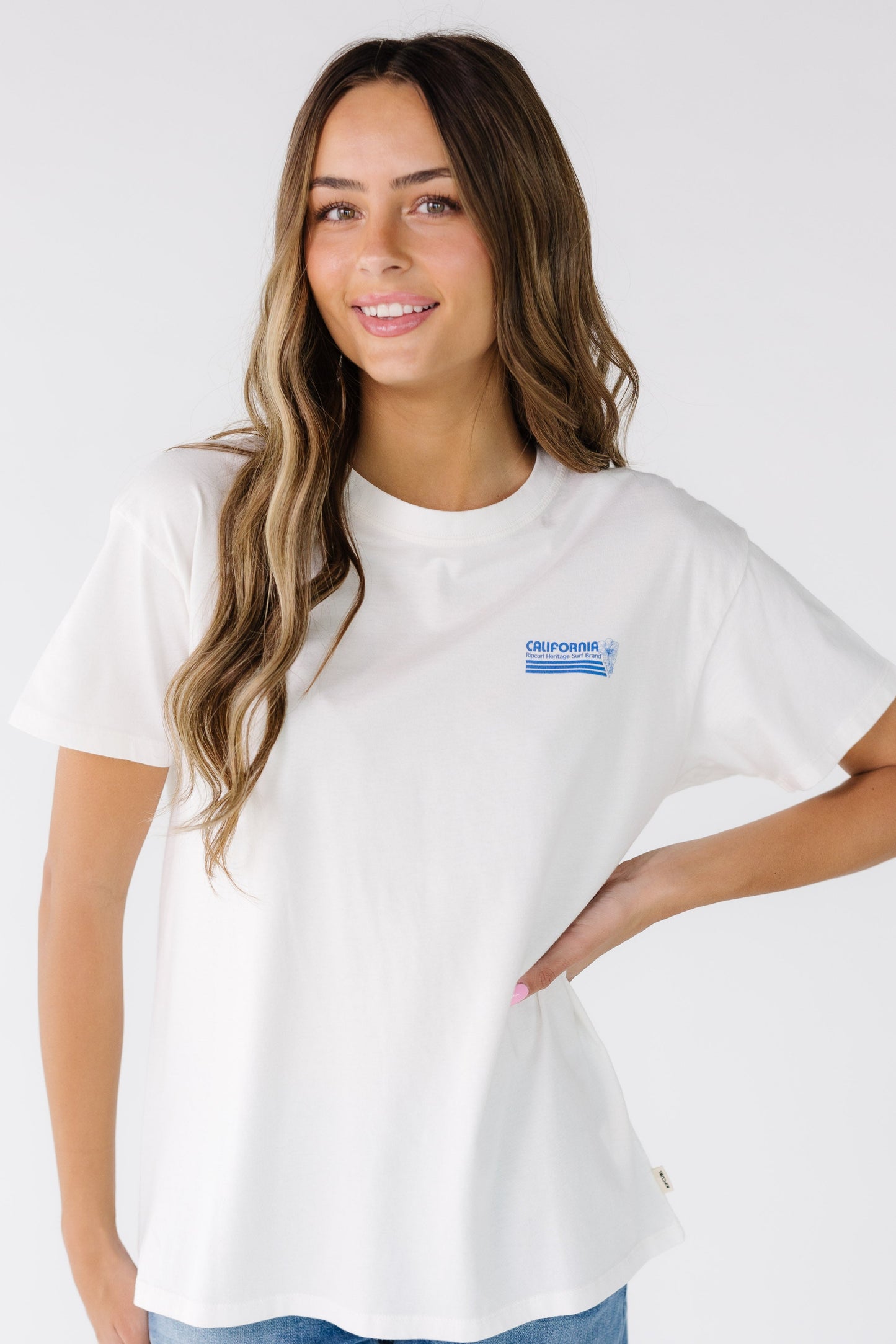 Woman wearing a modest white short sleeve tee by Rip Curl.