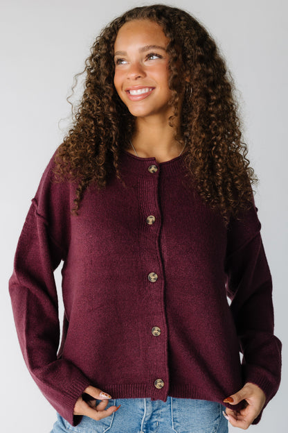 Woman wearing a long sleeve cardigan in dark cherry