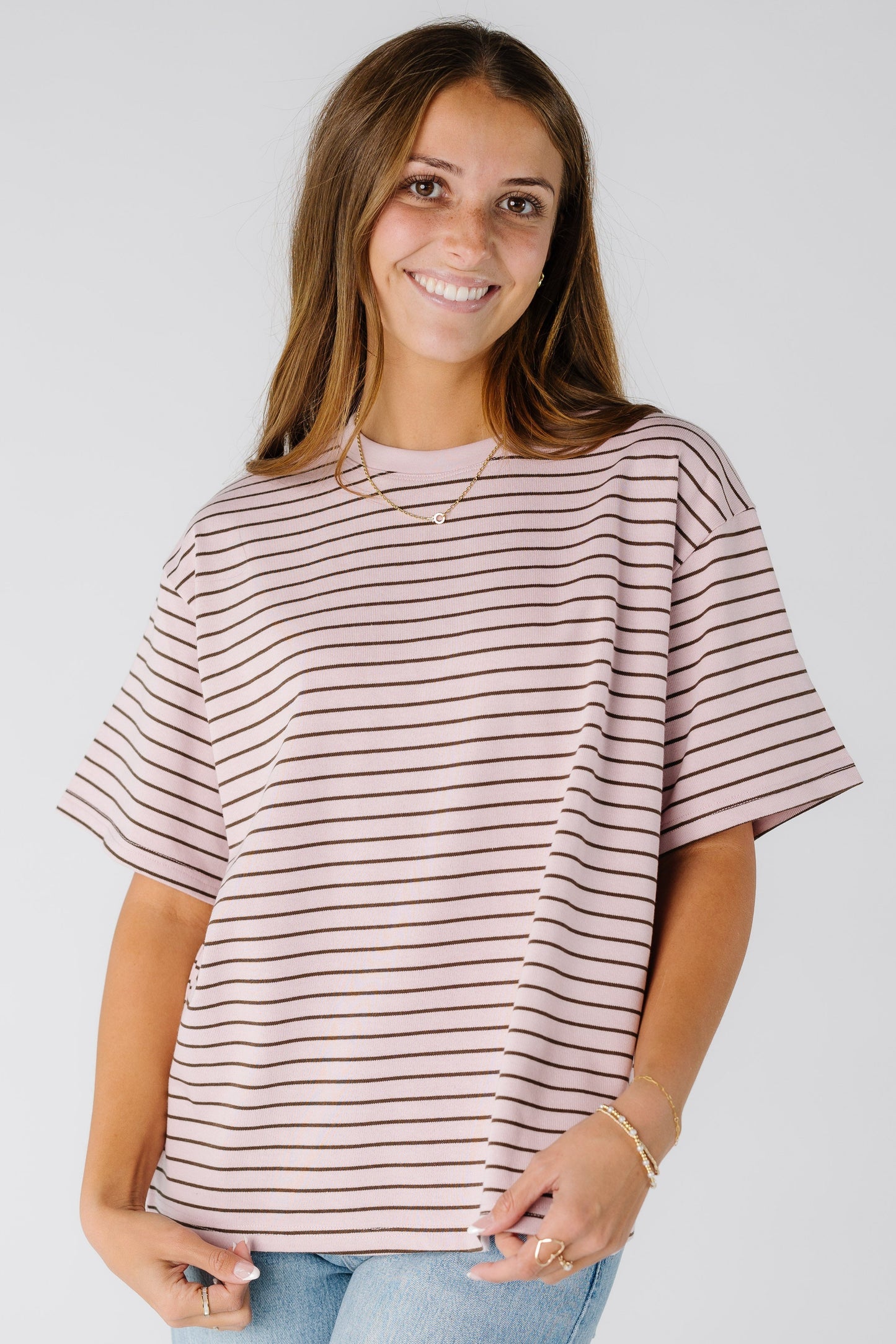 Woman wearing a modest pink boxy tee with short sleeves