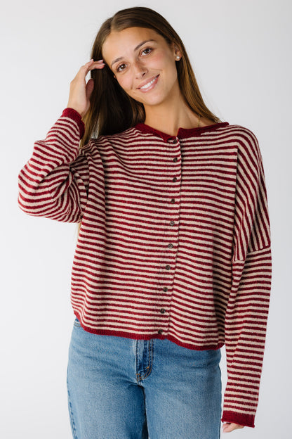 Woman wearing a loose fitting cardigan in red stripe with long sleeves
