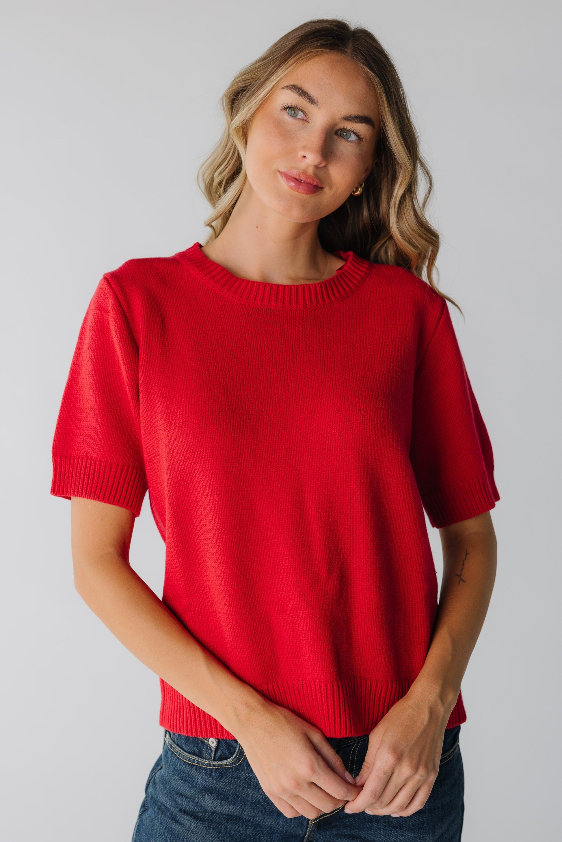 Woman wearing red short sleeve sweater