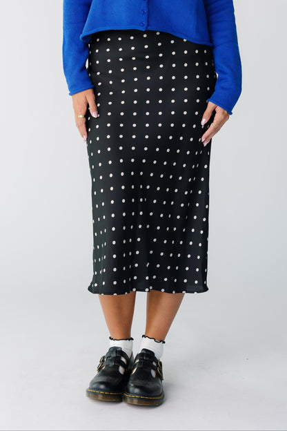 Woman wearing a black polka dot  A-line midi skirt