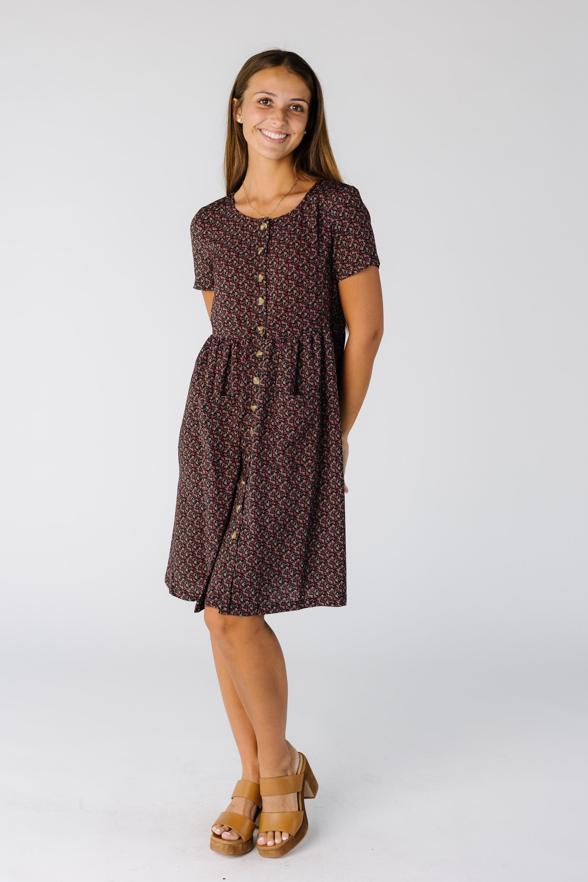 Woman wearing a loose fitting knee length dress with short sleeves