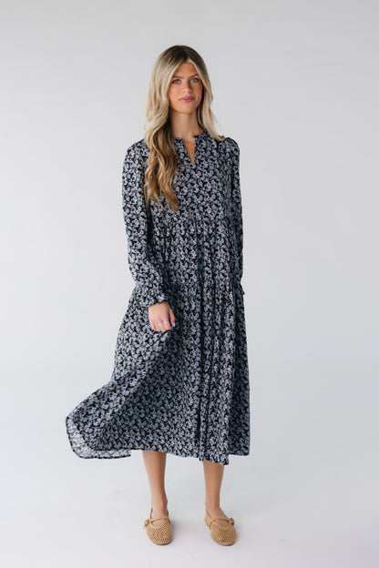 Woman wearing a blue floral dress with V-neckline