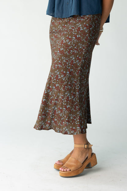 Woman wearing a brown floral print midi skit