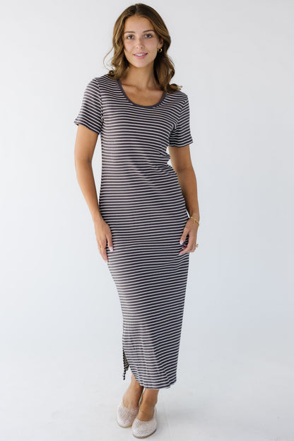 Young woman wearing a narrow brown and white stripe close fitting knit midi dress.