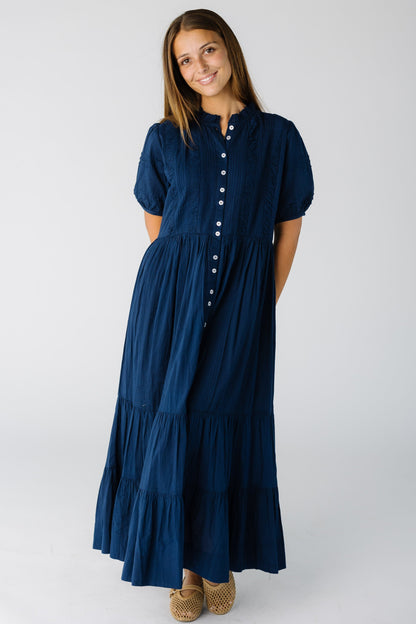 Woman wearing a modest navy midi-maxi dress with short puff sleeves