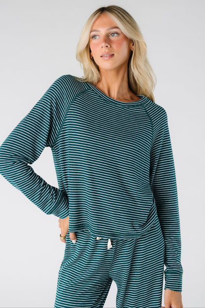 Woman wearing a green and white stripe soft lounge top