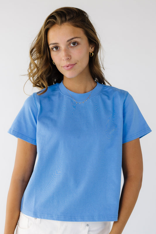 Young woman wearing a modest blue  short sleeve tee with a crew neckline