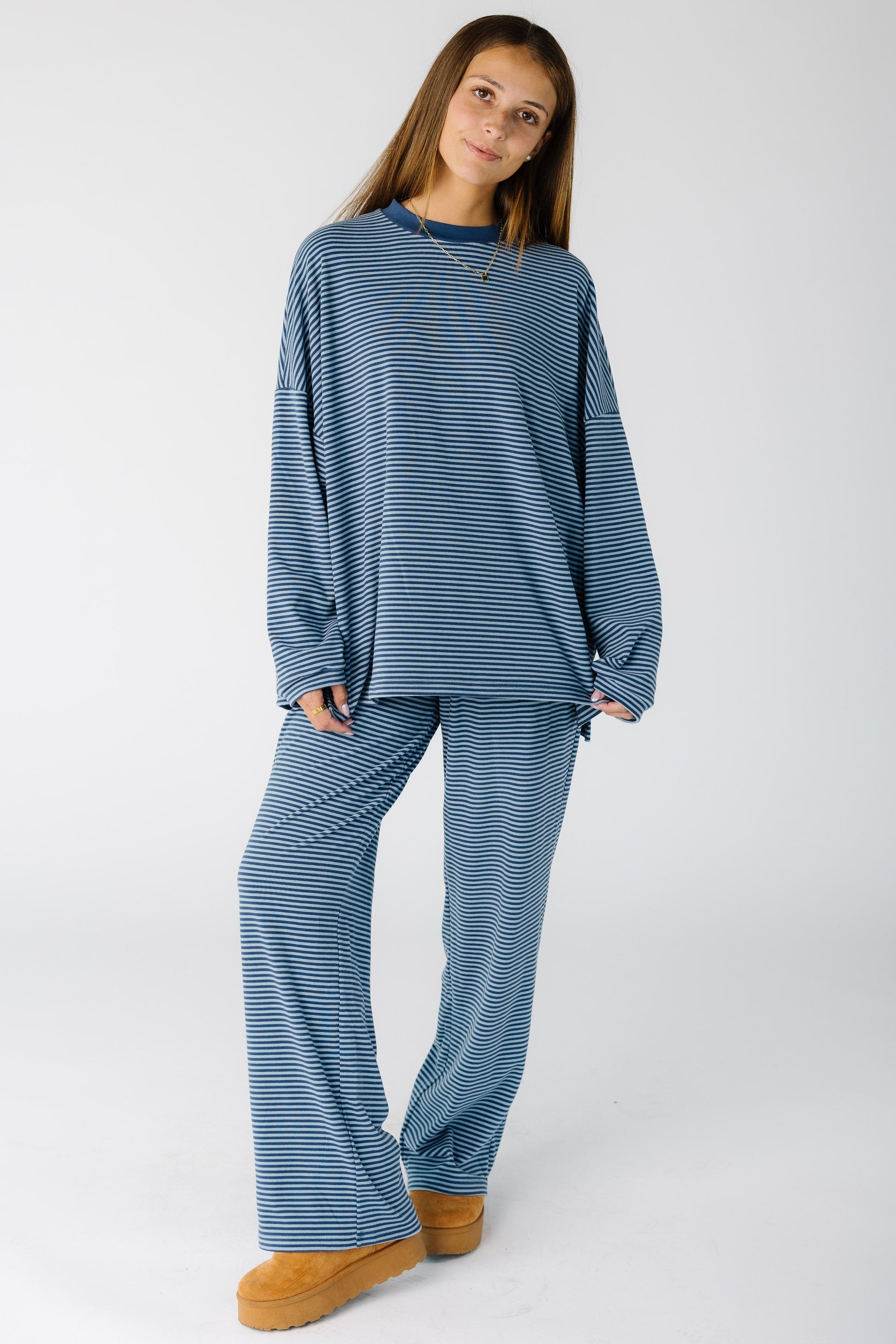 Woman wearing a loose fitting blue lounge  set with wide cut legs