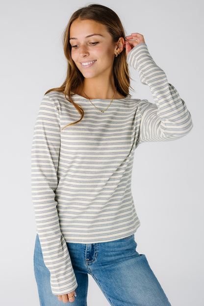 Woman wearing a modest striped top with a round neckline and long sleeves
