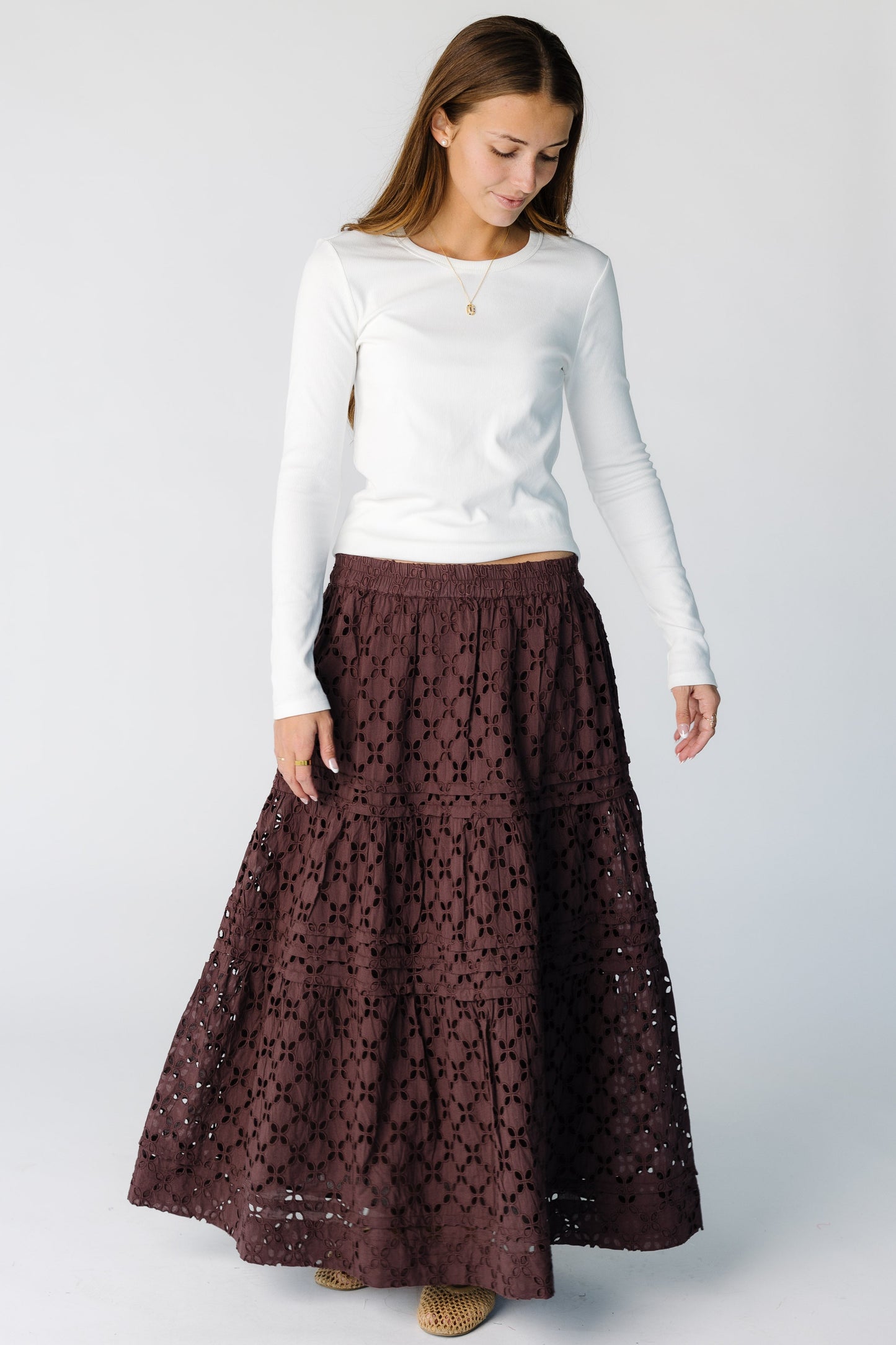 Woman wearing a brown eyelet tiered midi-maxi skirt with elastic waist