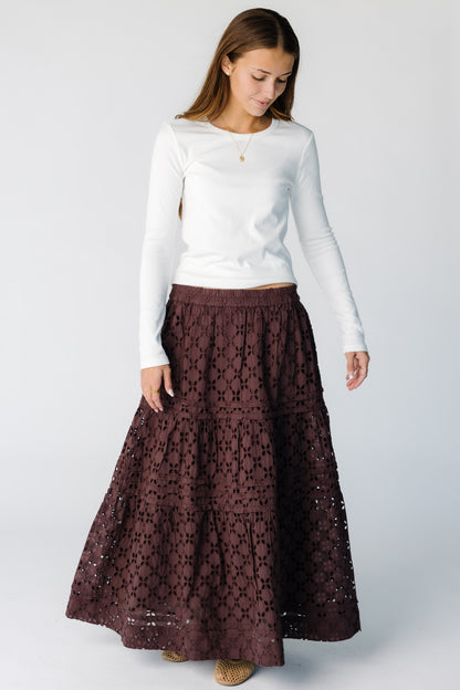 Woman wearing a brown eyelet tiered midi-maxi skirt with elastic waist