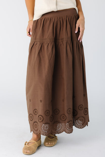 Woman wearing a brown eyelet midi skirt