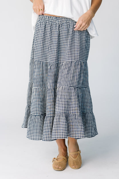Woman wearing a multi tiered navy gingham skirt