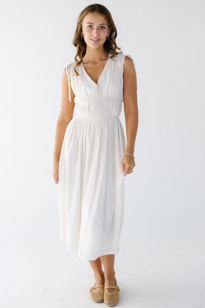 A sleeveless, romantic gauzy midi dress with elastic bodice details.