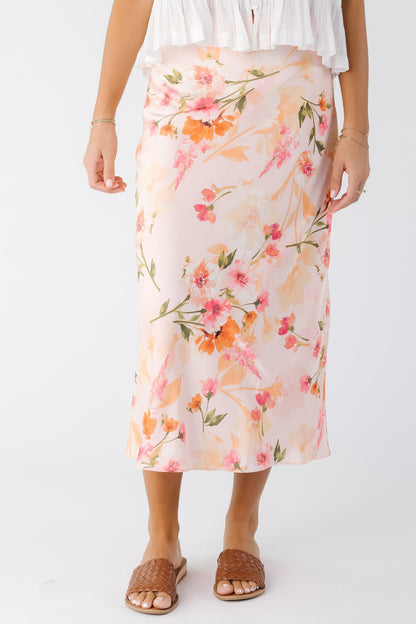 young woman wearing a pink floral A-line midi skirt 