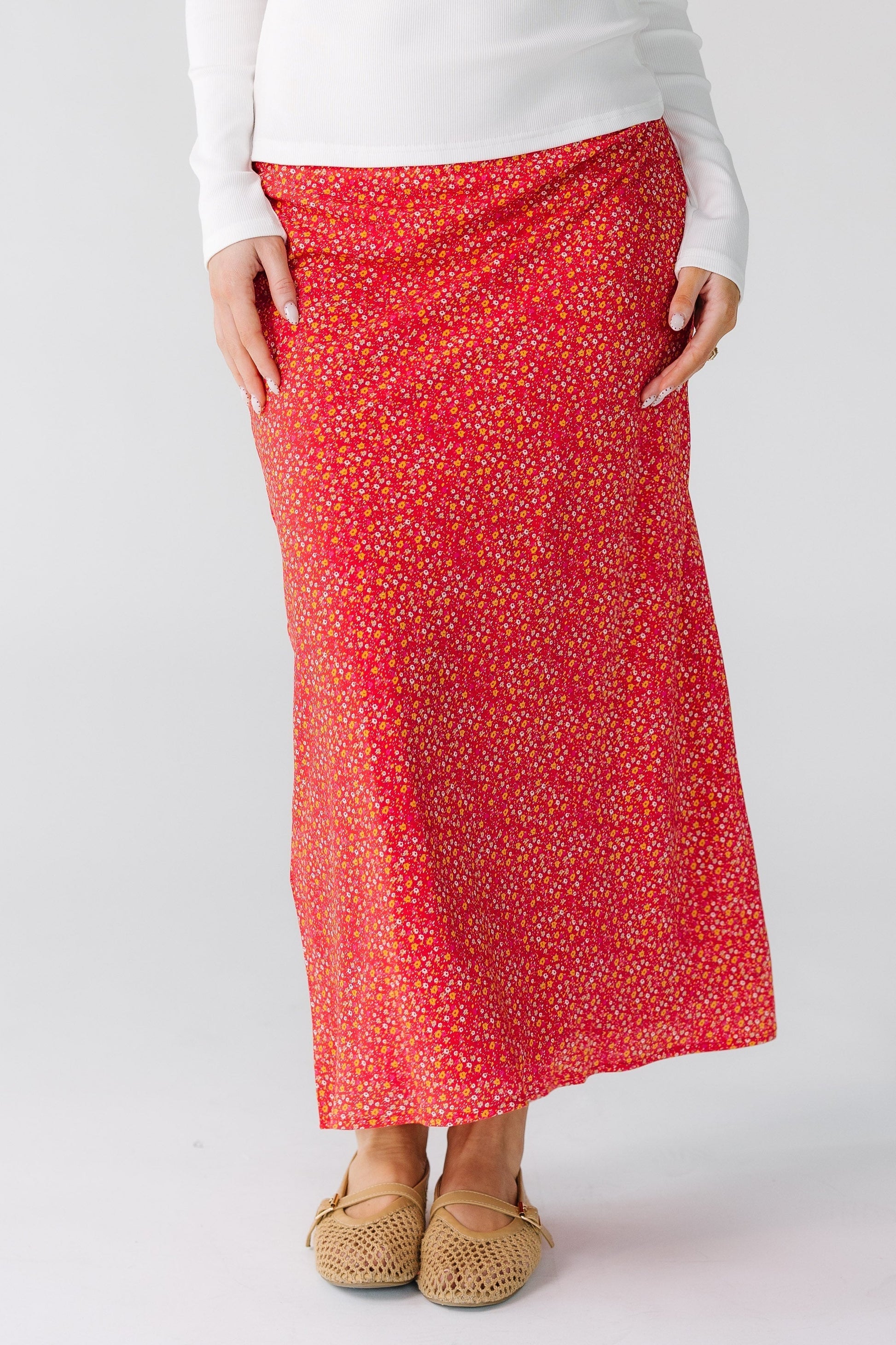 Woman wearing a red floral print mini dress with a high-low hemline.