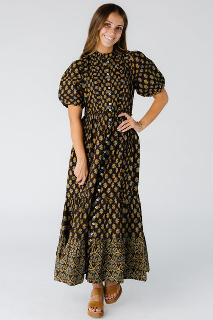 Woman wearing a brown floral button down dress with a full skirt