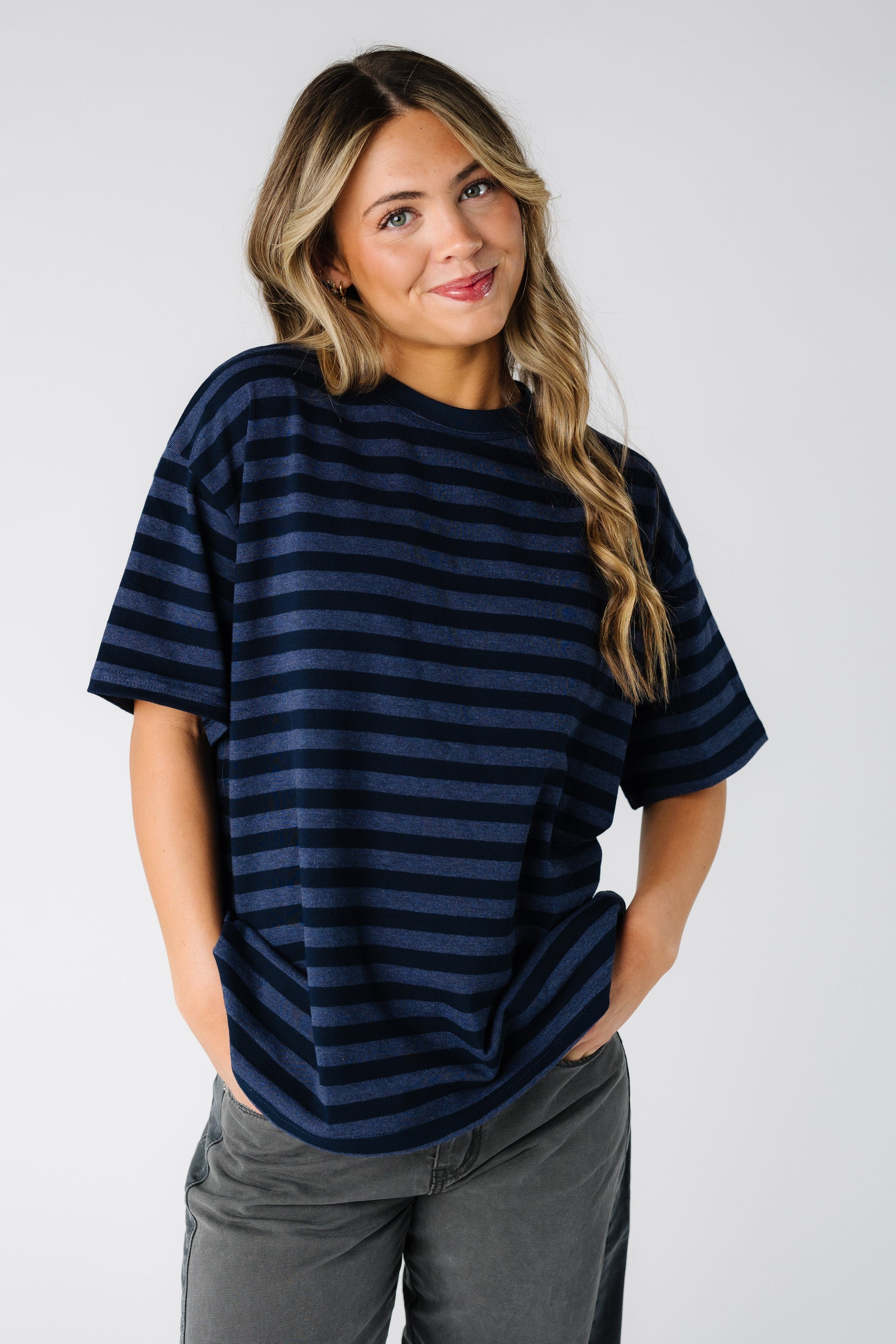 Woman wearing a modest navy stripe tee with short sleeves and a crew neckline