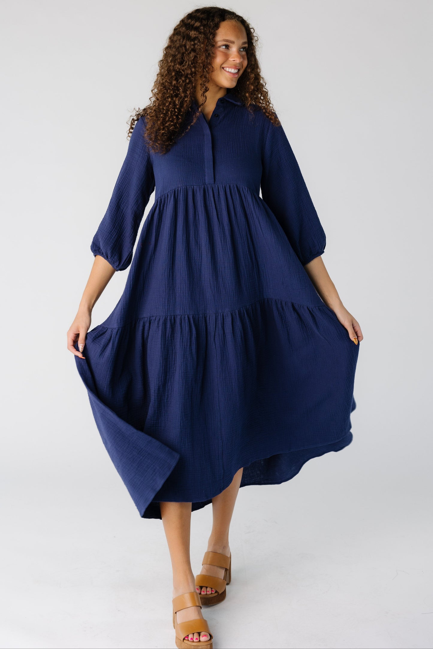 Teen girl wearing a navy midi with a very full skirt