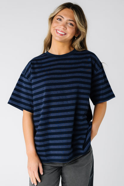 Woman wearing a loose fitting navy stripe tee with short sleeves