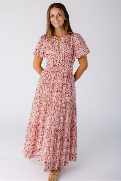 Woman wearing a pink print dress with full skirt and wide elastic waist