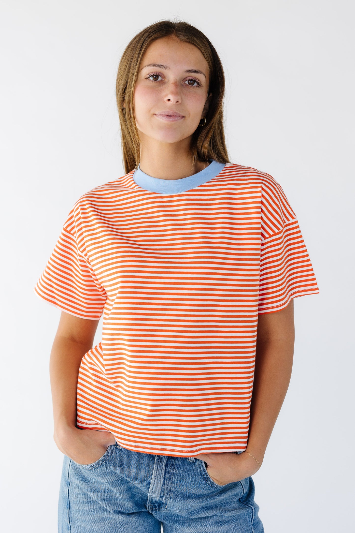The Jensen Top in orange & white stripe for women and teen girls.