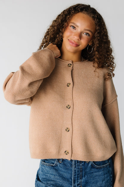 Woman wearing a taupe button cardigan with long sleeves