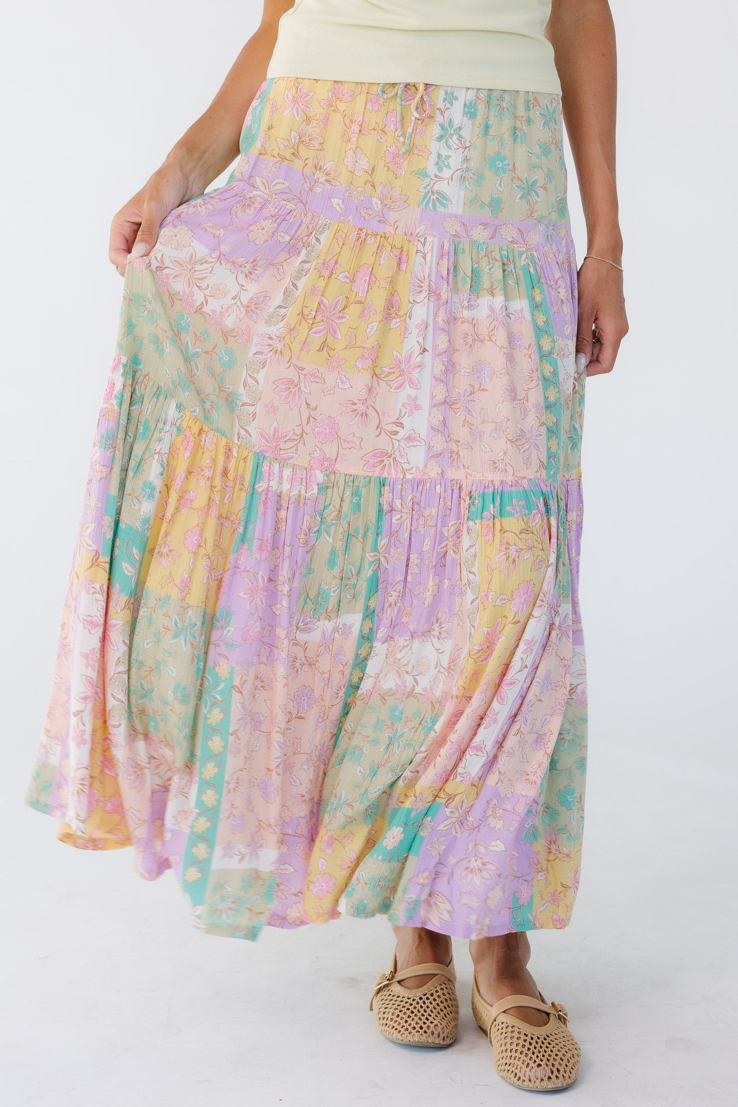 Young woman wearing a pastel multicolor midi skirt.