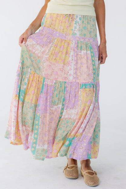 Young woman wearing a pastel multicolor midi skirt.