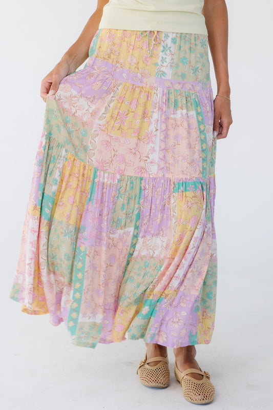 Young woman wearing a pastel multicolor midi skirt.