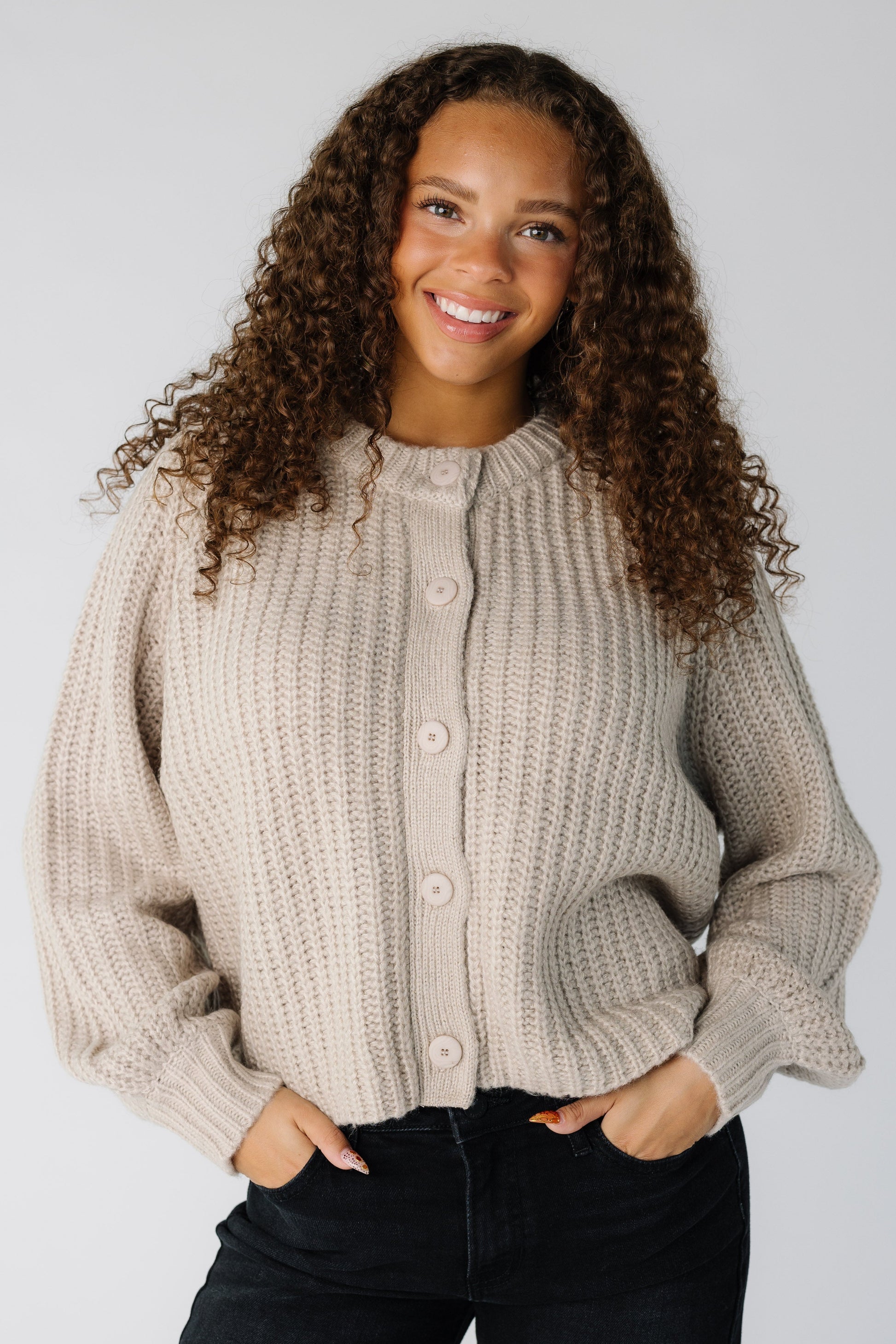 Teen girl wearing a light mocha loose fitting ribbed cardigan