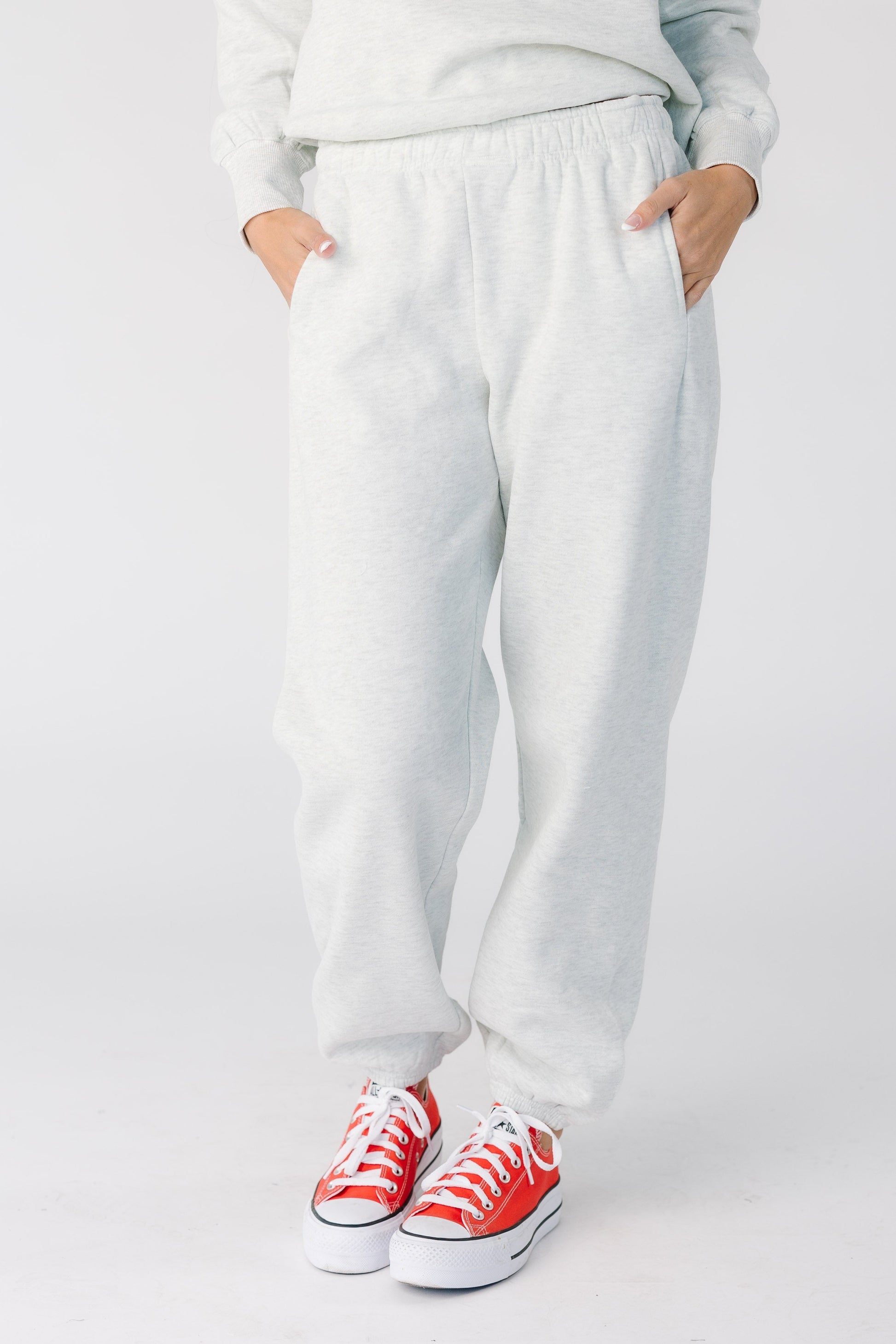 Woman wearing a pair of classic heather grey sweat pants